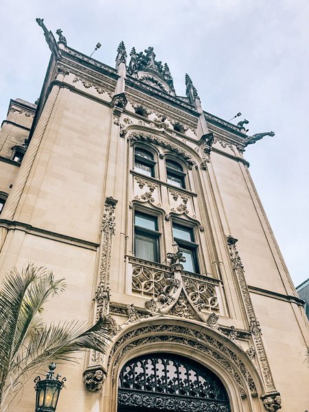 Outside Facade of Biltmore Estate with ornate architecture and one view of house with lamppost 