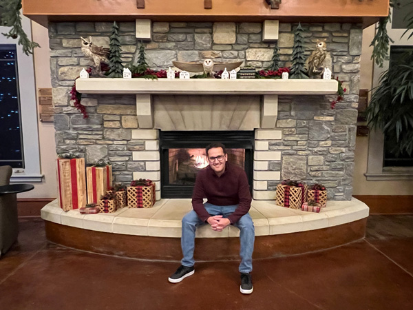 Tom sitting on fireplace