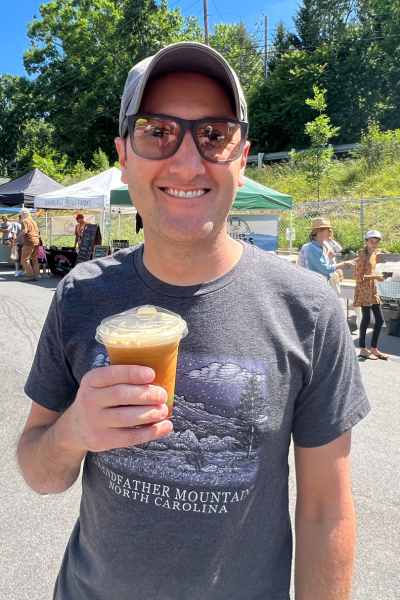 Tom with coffee at North Asheville Tailgate Market