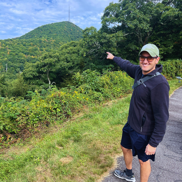 Tom pointing to Mount Pisgah from trailhead