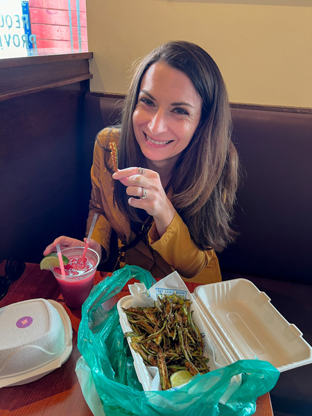 Christine eating Botiwalla's okra fries